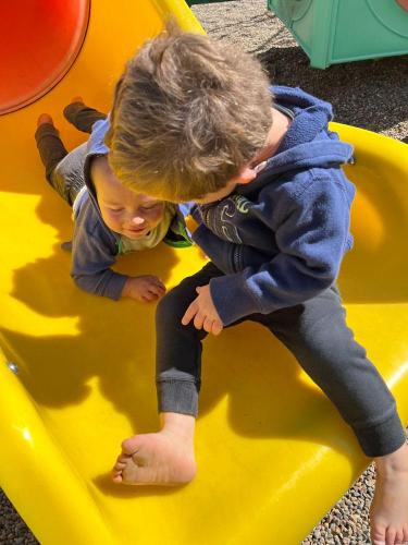 20220523-boys-sliding-together-Kalona-Park